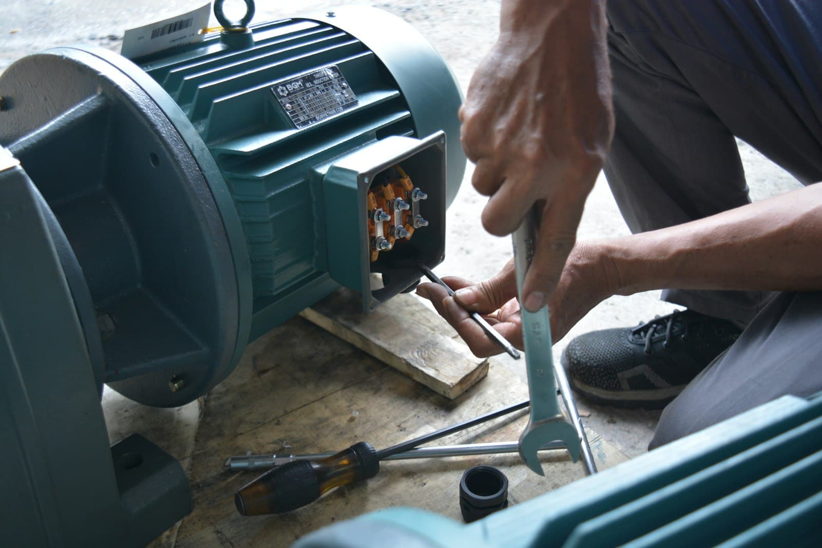 A technician repairing an industrial electric motor in the workshop